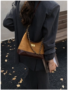 Detail of crossbody bag with ginger suede and brown leather patchwork and gold chain
