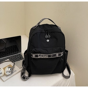 Close-up of black backpack with S.J.CHAO woven straps and a side water bottle pocket