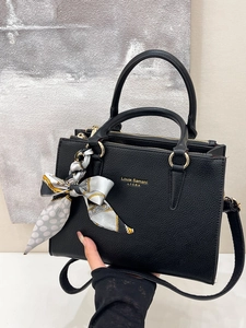 Premium black leather tote bag with silk scarf handle and gold zipper hardware details