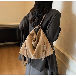 Close-up of khaki retro leather tote showing silver metal buckles and drawstrings