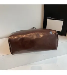 Detailed base view of deep brown leather tote bag with sturdy stitching and oil-wax texture