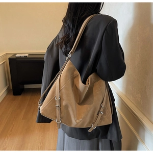 Detail shot of vintage khaki tote bag showing soft matte texture and silver metal buckles