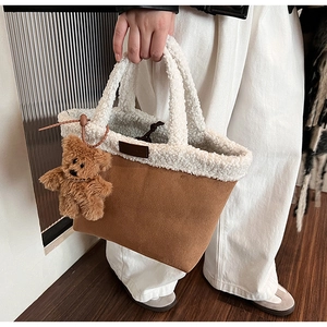 Detail view of winter fuzzy tote bag with brown suede base and soft white fleece handle