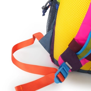 Detail of multi-color trekking backpack with mesh pocket and sturdy plastic buckles
