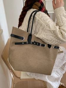 Fashionable khaki suede tote bag with black leather straps and silver buckle detail