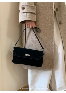 Minimalist black suede shoulder bag with silver metal swivel lock and long strap