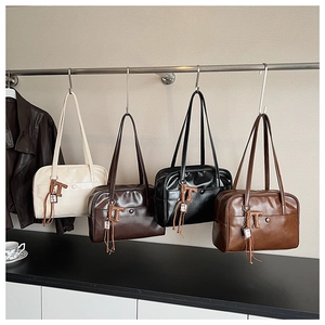Detail showing four vintage leather underarm bags in cream, brown, black, and caramel colors