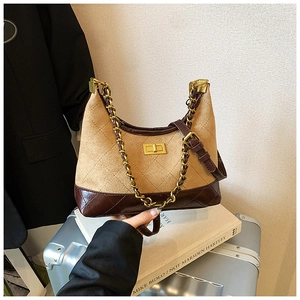 Detail of khaki suede quilted crossbody bag with brown faux leather and gold chain strap