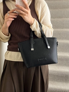 Women's black woven texture bucket bag with silver metal accents and dual handles