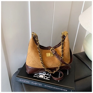 Detail of vintage contrast leather crossbody bag with quilted suede and gold chain strap
