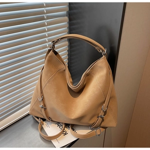 Detailed macro of vintage camel tote bag showing premium PU leather texture and silver hardware