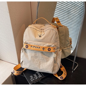 Detail of off-white and orange nylon backpack with adjustable branded straps and pockets