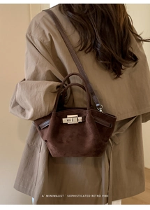 Brown suede bucket bag styled with a beige trench coat for a retro minimalist look