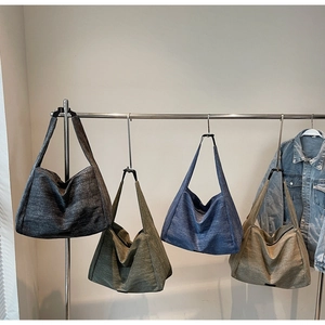 Detailed view of four colorful canvas hobo tote bags with wide shoulder straps
