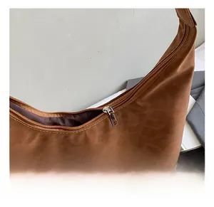 Close-up of leopard print tote bag showing metallic zipper and fabric lining details