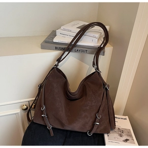 Detail of coffee brown tote bag showing soft faux leather texture and silver D-rings