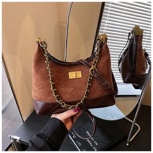 Detail showing vintage quilted shoulder bag with chain strap and metallic turn-lock closure