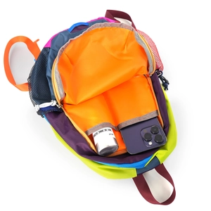 Detail view of colorful backpack interior showing multi-compartment storage and nylon lining