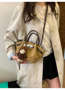 Retro mustard yellow suede bucket bag with brown leather straps and cute bear charm detail