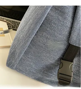 Detail of blue twill canvas tote bag featuring durable black strap and plastic buckle