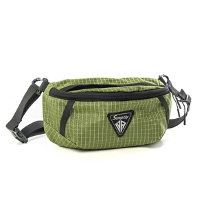 Detail of green checkered chest bag showing ripstop texture and triangular logo