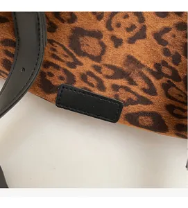 Macro shot of leopard print suede material with black leather strap and fine stitching