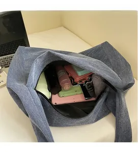 Detail view of large blue denim tote interior showing spacious storage for daily items