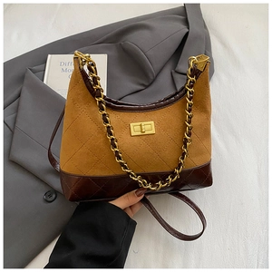 Close-up of caramel suede hobo bag with gold twist lock and woven chain strap details