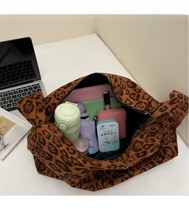 Macro shot of large leopard print tote bag interior showing ample storage for daily essentials