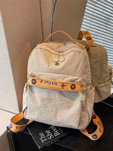 Fashionable beige nylon backpack with orange straps and spacious compartments for daily use