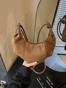 Retro caramel suede crescent bag with knot detail and minimalist vertical stitching