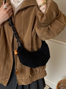 Vintage black crescent crossbody bag with braided rope strap and wooden bead tassel