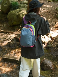 Lightweight contrast-color hiking backpack in navy blue with vibrant neon accents and logo