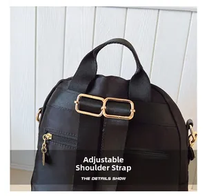 Detail view of adjustable black nylon shoulder straps with premium gold metal buckles