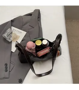 Interior view of minimalist shoulder bag showing storage for umbrella, wallet and cosmetics