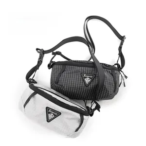 Detail of ripstop nylon chest bags in black and gray with adjustable straps and buckles