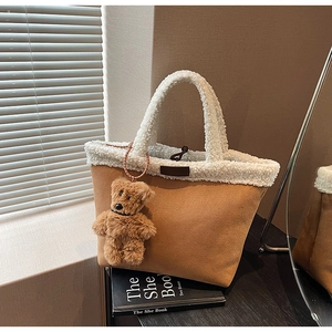 Brown suede tote bag with white faux fur trim and a cute plush bear charm detail