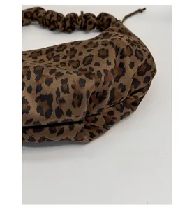 Detailed view of the leopard print tote bag featuring a reinforced bottom for extra durability