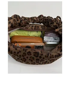 Macro detail of large capacity leopard print tote bag interior filled with daily essentials