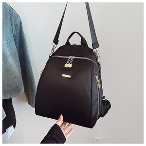 Detail of durable black oxford backpack featuring premium gold zippers and hardware accents