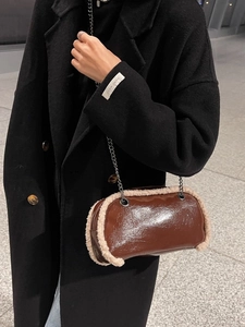 Brown glossy pillow bag with beige faux fur trim and vintage chain strap for winter style