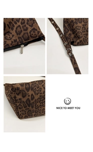Detail view of leopard print shoulder bag with metal zipper and adjustable buckle strap
