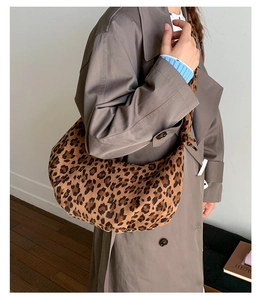 Detailed view of large leopard print hobo bag with knot strap detail on shoulder