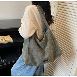 Detailed view of grey-green canvas tote bag with wide strap for casual daily commuting