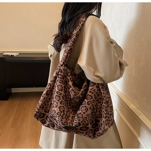 Leopard print suede tote bag worn over shoulder with oversized vintage aesthetic