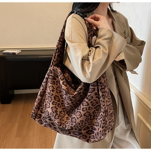 Detailed side view of leopard print suede tote bag with adjustable shoulder strap