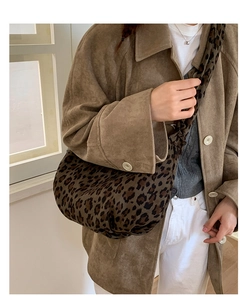 Detail of leopard print faux suede hobo bag with wide strap for autumn winter style