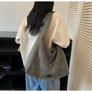 Detailed back view of a large grey canvas tote bag with wide strap for daily commute