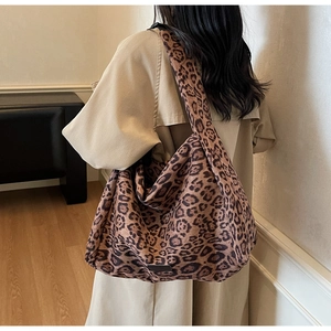Detail of the leopard print faux suede tote bag showing its slouchy texture and wide strap