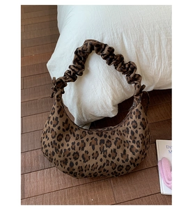 Detail of leopard print hobo bag with unique cloud-pleated handle and vintage knot design